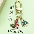 Christmas keychain with tree and candy cane charms in gold finish, size 5.5cm x 1.2cm - Christmas Tree & Candy (ER409)