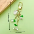 Elegant lily of the valley flower keychain pendant with golden metal chain and white petals - ER1640 / Gold White Lily Gold Shell Leaf