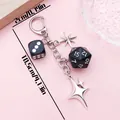 Detail view of black dice keychain with silver stars showing dimensions 10.5cm by 2cm. - 2x10.5cm / Black Resin Dice Four-Pointed Star D-Ring (ER2157)