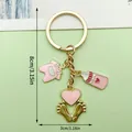 Cute baby themed keychain with pink clothes and bottle charms in golden finish - Pink Clothes Milk Bottle Heart Footprints Style (ER1519)