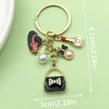Detailed view showing 8.1cm by 3cm dimensions of a stylish handbag and lipstick charm keychain. - Black Bag Lipstick Hat Style (ER596)