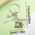 Detail view of sewing machine keychain with ruler and scissors charms showing size dimensions - Sewing Machine Scissors Ruler Dress (ER339)
