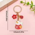 Oriental Maneki Neko lucky cat keychain with red sakura blossom charm in gold finish - Fortune Sakura (ER1911) / 1 Piece (3x8.5cm) / Red/Gold