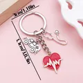Close-up of a medical keychain with heart, stethoscope, and ambulance charms - Stethoscope ECG Ambulance (ER2161) / Antique Silver