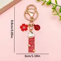Traditional lucky cat keychain with red sakura and fortune charms in golden finish - Prosperity Blessing (ER1908) / 1 Piece/Pack (3X9.8CM) / Red/Gold