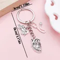 Silver medical keychain featuring anatomical heart, stethoscope, and ambulance charms. - Heart Stethoscope Ambulance (ER2159) / Antique Silver