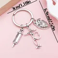 Creative silver-tone medical keychain featuring syringe stethoscope and heart charms - Syringe Anatomical Heart (ER2162)
