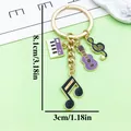 Retro alloy music note keychain featuring guitar and piano charms, measuring 8.1cm - Purple Music Note Piano Violin Style (ER2201)