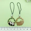 Cute panda metal phone charm strap showing both front and back designs with ruler for scale - Chinese Style Panda on Back (ER981)