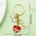 Medical theme keychain with heart, stethoscope, and nurse hat charms in gold finish - Heart Nurse Hat Stethoscope Keychain (LS591)
