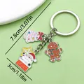 Festive Christmas keychain featuring Santa Claus, tree, and gingerbread man charms. - Santa Claus, String Lights, Gingerbread Man & Christmas Tree (ER827) / Silver White