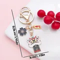 Elegant Chinese lion dance keychain with golden lucky charms and floral pendant - Luck Sakura Lion Dance (ER2147) / 3x8.8cm / Black