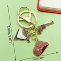 Western cowboy themed keychain featuring a brown hat and revolver charm accessory - Brown Enamel Hat Pistol (ER1259)