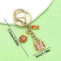 Llavero dorado tradicional con amuletos de la suerte rojos, tamaño 7,7x3cm, vista SKU - Gato de la Suerte Fortuna (ER895)