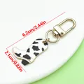 Western cow print cowboy boot keychain with gold lobster clasp and dimensions - Western Cowboy Boot Style (ER2273) / 2.1x6.2cm (4.4g) / Black and White