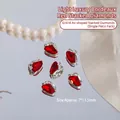 Bordeaux red shield-shaped nail art crystals with silver accents on reflective surface. - Axe Style (G1618) / 1 Piece
