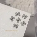 Elegant silver bow nail art charm with delicate pearls and sparkling rhinestones, 10x11.5mm - Pearl Bow Style (G1634)