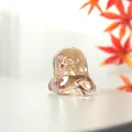 Close-up macro view of a translucent iridescent crystal ghost figurine for Halloween decor - Short Ghost Style / 44x43mm / Champagne