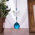 Close-up of blue faceted crystal ball suncatcher with metal butterfly ornament - Butterfly Suncatcher / Lake Blue