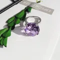 Close-up of a large purple crystal napkin ring with silver-colored metal setting - 20mm Napkin Ring / Purple
