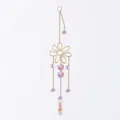 Close-up of golden flower suncatcher with decorative purple stones and AB crystal prism - Flower Style