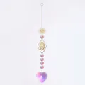 Close-up detail of the sparkling heart-shaped AB crystal pendant on a gold suncatcher - Floral Set 6