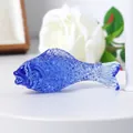 Close-up shot of a decorative vibrant blue crystal fish ornament with textured scales - 70mm Fish / Medium Blue