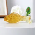 Detailed side view macro shot of a decorative golden amber crystal fish glass figurine - 70mm Fish / Gold