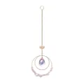 Macro detail of a crystal suncatcher hanging ornament with lotus charm and pink crushed stones - Pink Stone Style