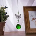Decorative green crystal ball sun catcher featuring a metallic butterfly charm in a cozy home setting - Butterfly Suncatcher / Green