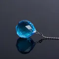 Vue détaillée d'un pendentif boule en cristal bleu facetté avec une chaîne en métal argenté - Pendentif Chaîne à Billes 40 / Bleu lac