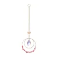 Detail showing iridescent crystal drop and lotus charm on gold hanging suncatcher. - Watermelon Red Stone Style