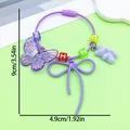 Close-up of a purple resin butterfly and gummy bear keychain with colorful letter beads. - Fancy Butterfly Bowknot Bear Letter Bead Keychain (ER2090)