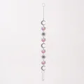 Detailed view of iridescent suncatcher hanging ornament with silver crescent moons and suns - Moon