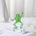 Macro view of a handcrafted green glass kung fu frog figurine on a clear crystal base - Kung Fu Frog with Base Pushing Palm
