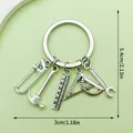 Tool-themed metal keychain with saw and hammer charms, measuring 5.4cm by 3cm, silver finish - Multifunction Ruler Triangle Style (LS219)