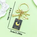 Detailed view of black alloy moon tarot card keychain with sun and cross charms and dimensions - The Moon Style (ER2178)