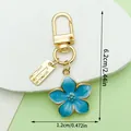 Blue enamel cherry blossom keychain with gold metal plating and dimension markings - Cherry Blossom Style (LS524) / Blue