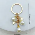 Exquisite handmade gold keychain featuring white pearls and star pendants, 7.3cm length - 五角星款(LS426) / 3x7.3cm / Gold