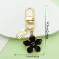 Black enamel cherry blossom flower keychain with gold hardware and detailed size markers - Cherry with Tag Style (LS528)