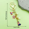 USA Independence Day keychain with stars stripes hat and boot charms in a golden finish. - Artificial Pearl Hat Boot Style (ER1665)