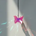 Detail of pink crystal butterfly suncatcher creating colorful light reflections on wall - Brown Rope / AB Color
