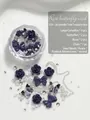 Nail art charm kit with purple camellias, bows, butterflies, silver chains, and pearls. - Jacaranda Tree Box