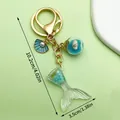Elegant gold ocean themed keychain with mermaid tail, blue shell and pearl charms - Sequin Mermaid Tail Shell Glass Ball Style (LS169) / 13.5g / Blue