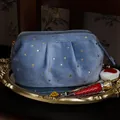 Blue velvet cosmetic storage bag with gold star prints on a luxury vintage gold tray - Small Shell Style / Baroque Blue