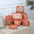 7-piece terracotta travel luggage organizer set for efficient clothes and shoe storage. - Brick Red