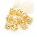 Detailed macro view of 14K gold-plated jewelry spacer beads with micro-pave zircons - White Zirconia (GF-464) / 18K Gold