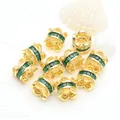 Close-up of 14K gold-plated spacer beads featuring emerald green micro-set zircons - Green Zirconia (GF-464) / 18K Gold
