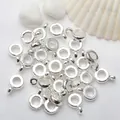 Detailed macro view of shiny silver circular pendant loops for DIY jewelry making - Small Diameter 3.8mm / Silver (Color Retention)