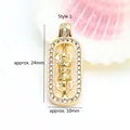 Detailed view of a rotating 18K gold plated Vajra pendant with zircon, 24x10mm - Vajra Style (GF-465 Style 1) / 5 Pieces/Pack